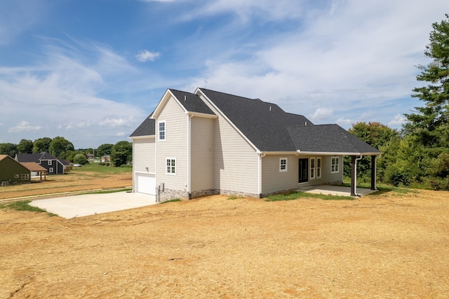 rear view of house with a garage