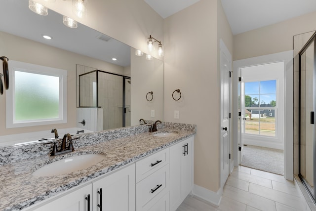 bathroom featuring vanity, plus walk in shower, and tile patterned flooring