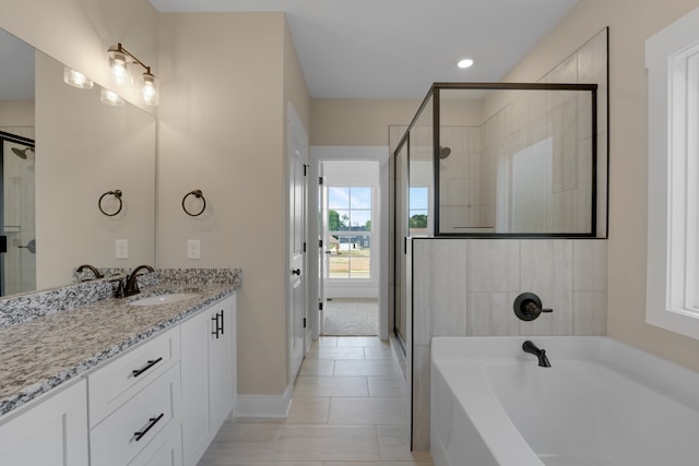 bathroom with vanity, plus walk in shower, and tile patterned floors