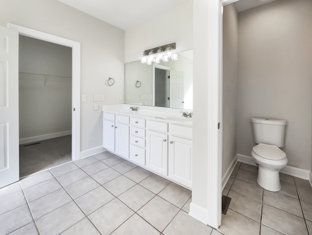 bathroom with vanity, toilet, and tile patterned floors