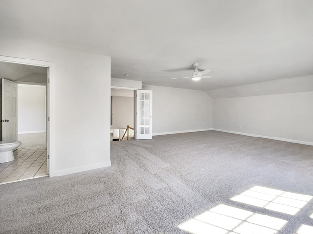 interior space with ceiling fan and light colored carpet