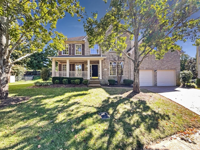 view of front of property with covered porch, a front yard, and a garage