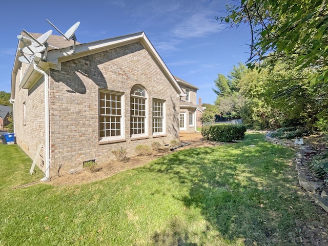 rear view of property with a lawn