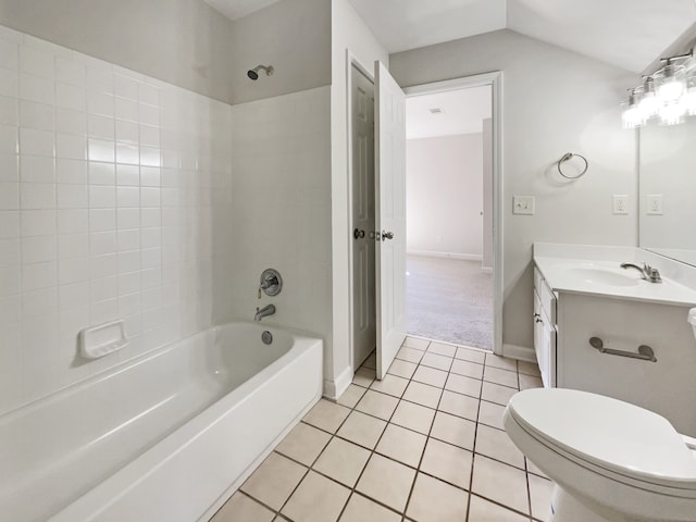 full bathroom featuring vanity, tiled shower / bath combo, toilet, and tile patterned flooring