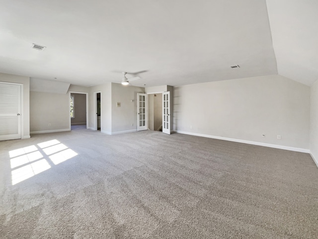 unfurnished living room featuring ceiling fan, lofted ceiling, and carpet floors