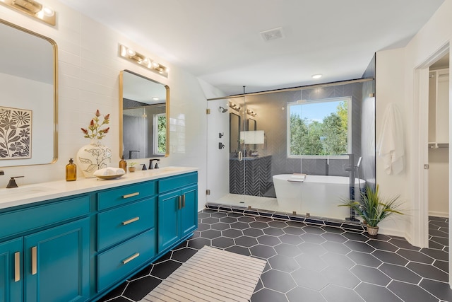 bathroom featuring tile walls, vanity, shower with separate bathtub, and tile patterned floors