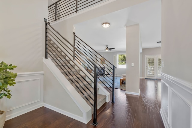 staircase featuring ceiling fan and wood-type flooring