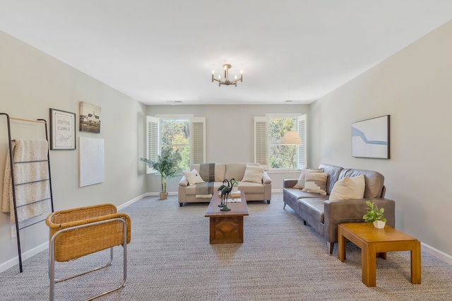 carpeted living room featuring a chandelier