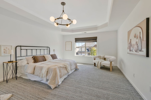 bedroom featuring ornamental molding, a chandelier, carpet flooring, and a tray ceiling