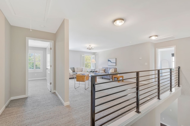 hall featuring light colored carpet