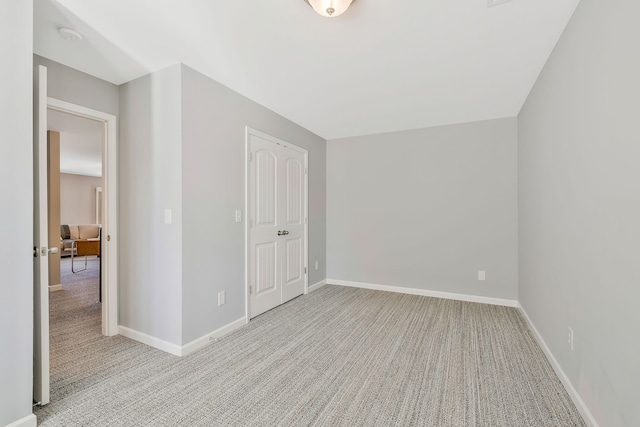 interior space with a closet and light colored carpet