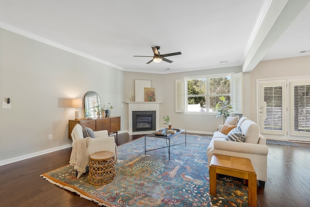 living room featuring crown molding, ceiling fan, and dark hardwood / wood-style flooring