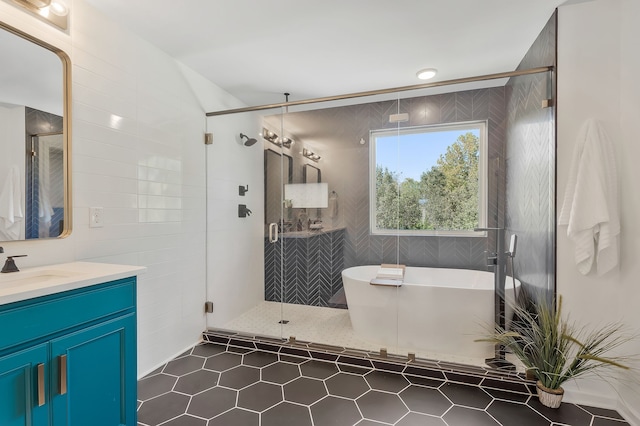 bathroom featuring vanity, independent shower and bath, and tile patterned flooring