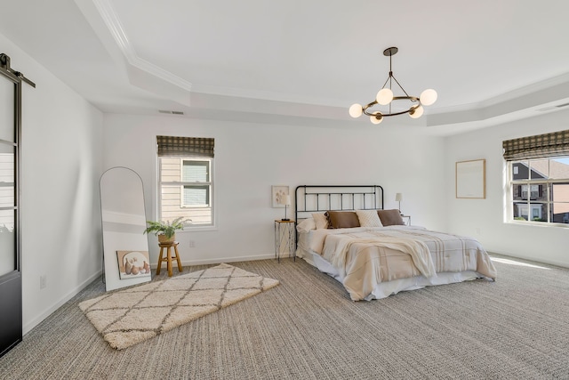 bedroom with crown molding, carpet flooring, and a tray ceiling