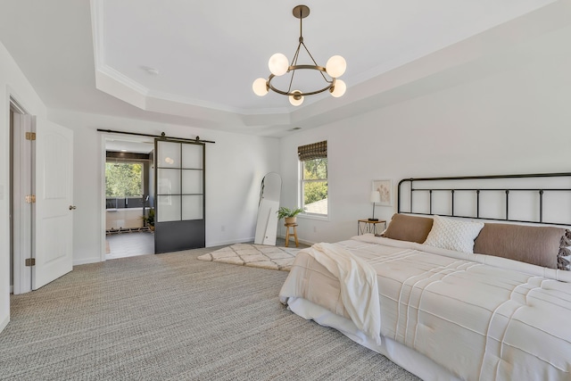 carpeted bedroom featuring multiple windows, a barn door, a tray ceiling, and crown molding