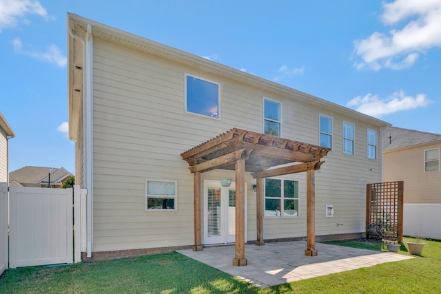 rear view of house with a patio, a yard, and a pergola