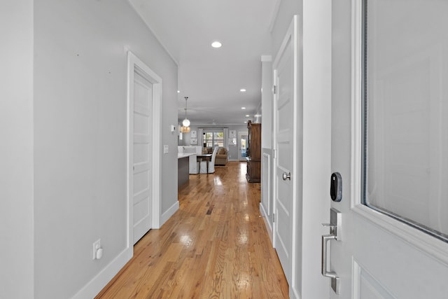 hallway with light hardwood / wood-style floors