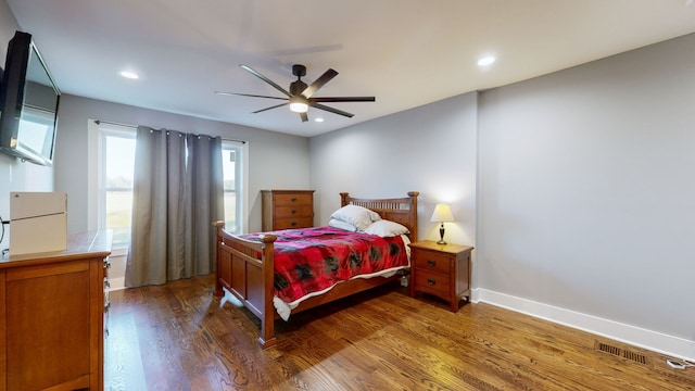 bedroom with ceiling fan and dark hardwood / wood-style flooring