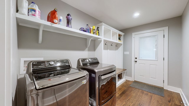 laundry room featuring dark wood-type flooring and separate washer and dryer