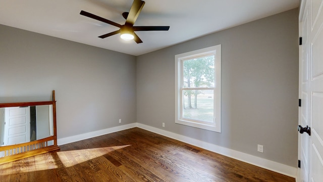 unfurnished room with ceiling fan and dark hardwood / wood-style floors