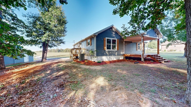 view of side of home with central air condition unit and a wooden deck