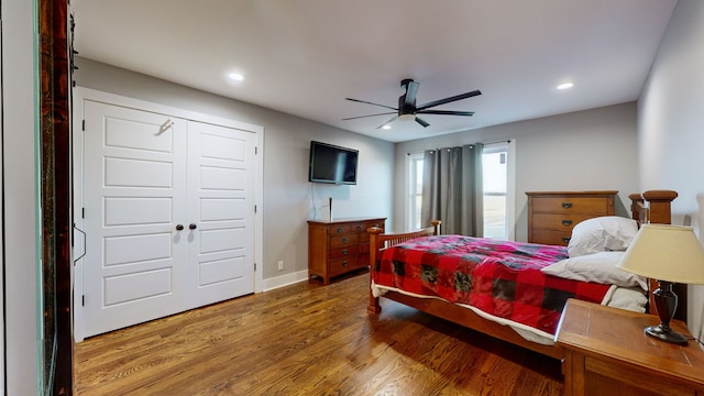 bedroom with a closet, ceiling fan, and wood-type flooring