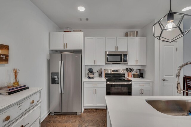 1677 54th Ave N Unit 218, Nashville, TN 37209 - kitchen featuring stainless steel appliances, a sink, dark wood-style floors, light countertops, and white cabinets