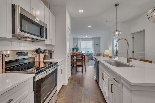 kitchen featuring appliances with stainless steel finishes, white cabinetry, sink, and dark wood-type flooring