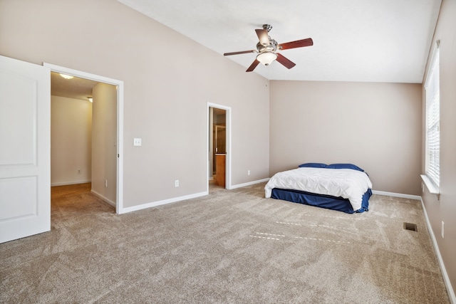 carpeted bedroom with lofted ceiling, baseboards, visible vents, and a ceiling fan