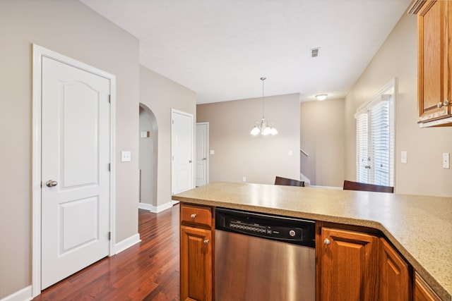 kitchen with dark wood-style flooring, visible vents, hanging light fixtures, light countertops, and dishwasher