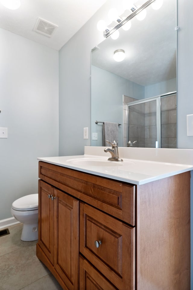 bathroom featuring a stall shower, visible vents, vanity, and toilet