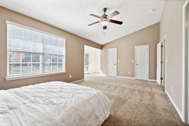 carpeted bedroom featuring ceiling fan, baseboards, and vaulted ceiling