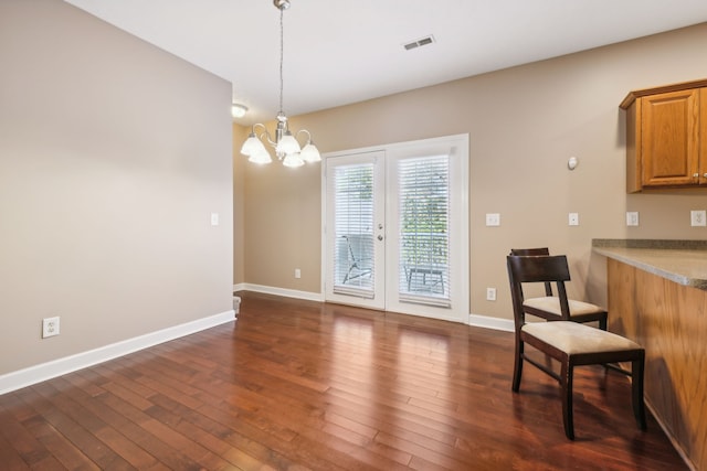 dining room with an inviting chandelier, baseboards, visible vents, and dark wood finished floors