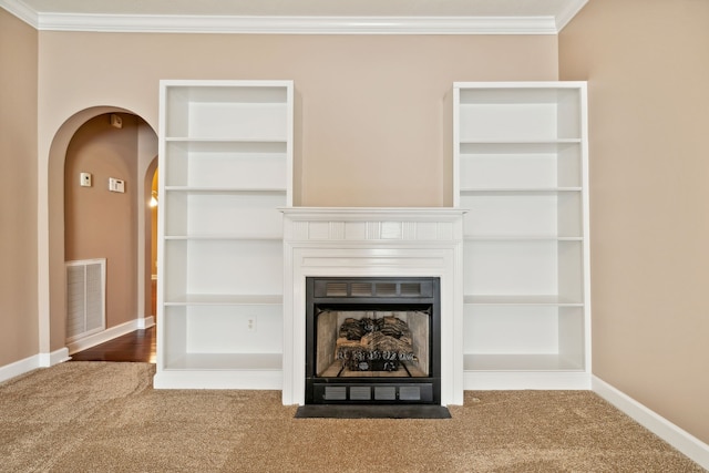 unfurnished living room with a fireplace, carpet flooring, visible vents, baseboards, and crown molding