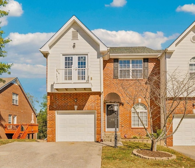 view of front of house with a garage, driveway, and brick siding