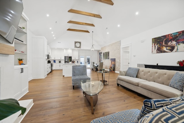 living room with beamed ceiling, high vaulted ceiling, and light wood-type flooring