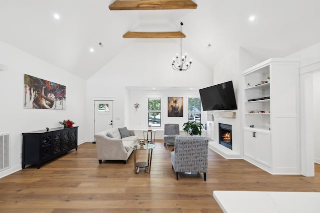 living room featuring beam ceiling, a notable chandelier, wood-type flooring, and high vaulted ceiling