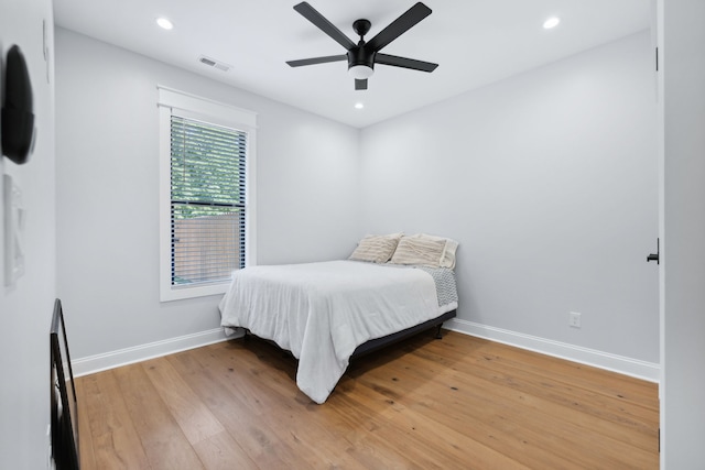 bedroom with hardwood / wood-style floors and ceiling fan