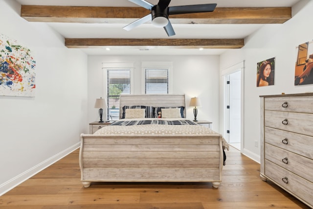 bedroom featuring light hardwood / wood-style flooring, beamed ceiling, and ceiling fan