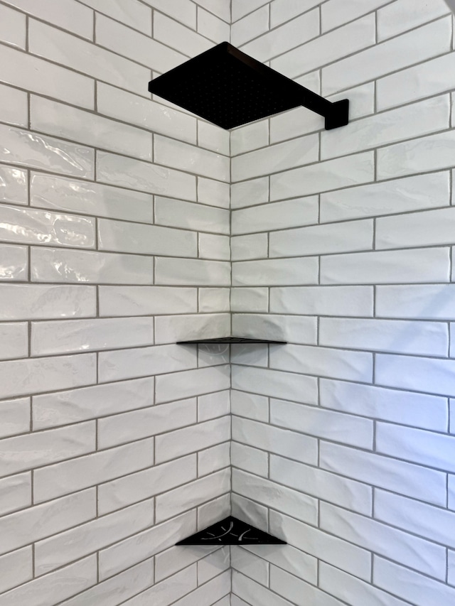 bathroom with a tile shower