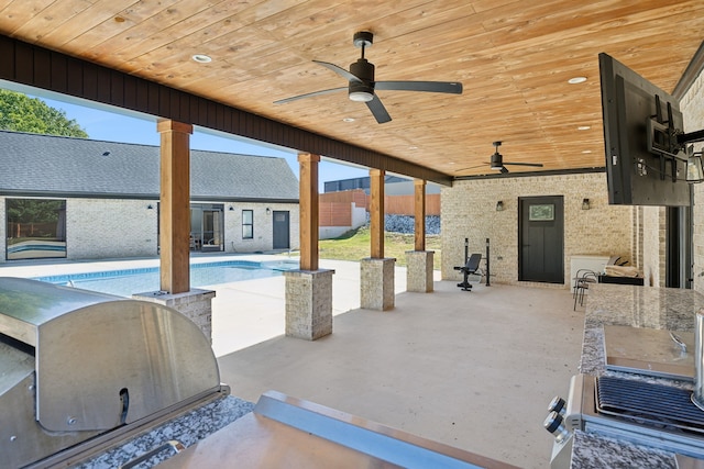 exterior space with ceiling fan, a patio area, and a grill