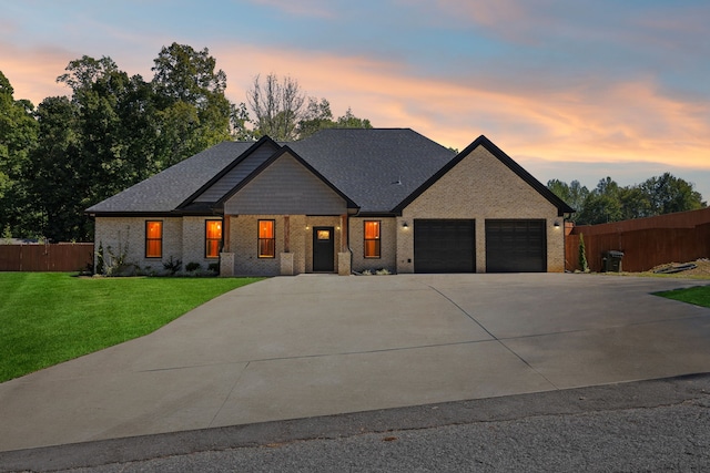 view of front of home featuring a yard and a garage