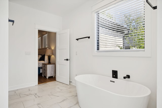 bathroom featuring a healthy amount of sunlight and a bath