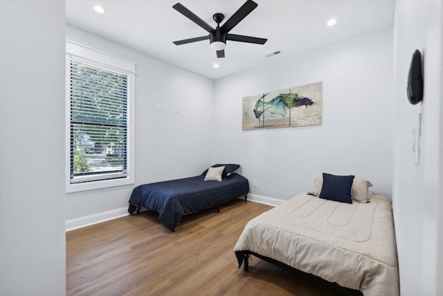 bedroom with hardwood / wood-style flooring and ceiling fan