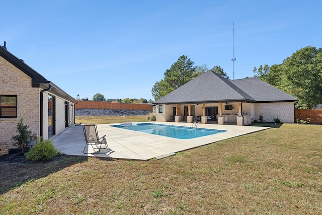 view of swimming pool with a patio and a yard