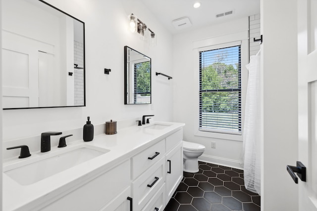 bathroom featuring vanity, toilet, and tile patterned floors