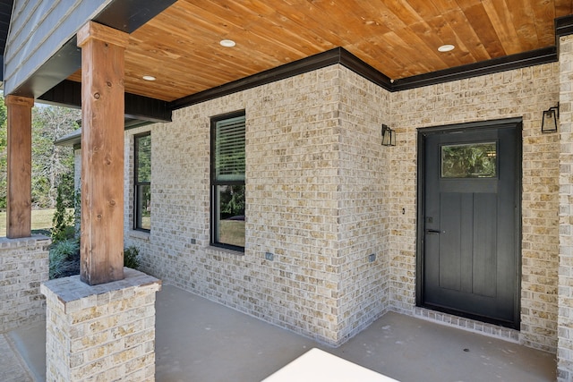 view of exterior entry with covered porch