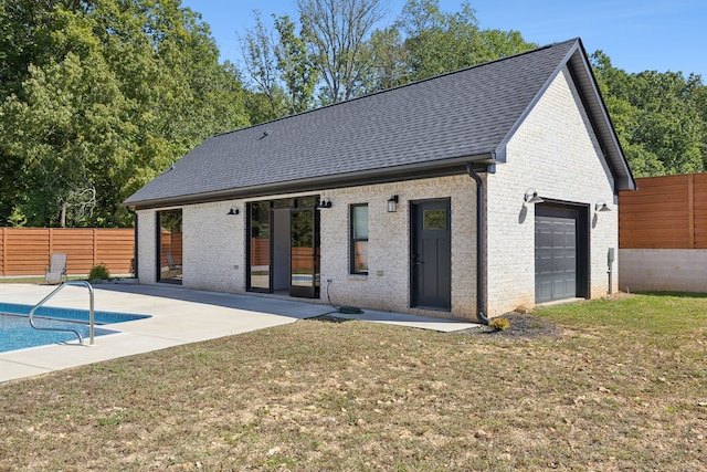 rear view of house featuring a yard, a patio, and a fenced in pool