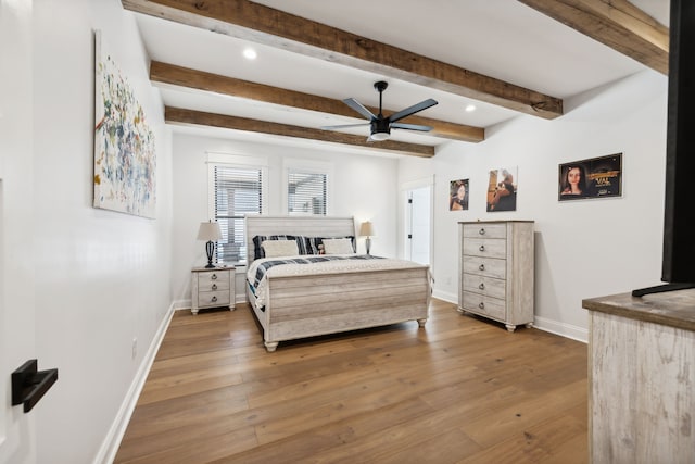 bedroom featuring beamed ceiling, wood-type flooring, and ceiling fan