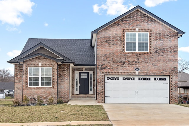 front facade featuring a front yard and a garage